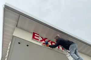Washing Exxon sign at gas station daylight
