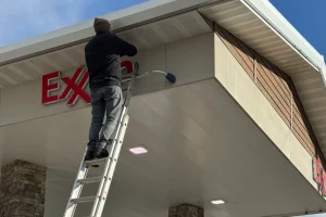 Exxon sign being cleaned